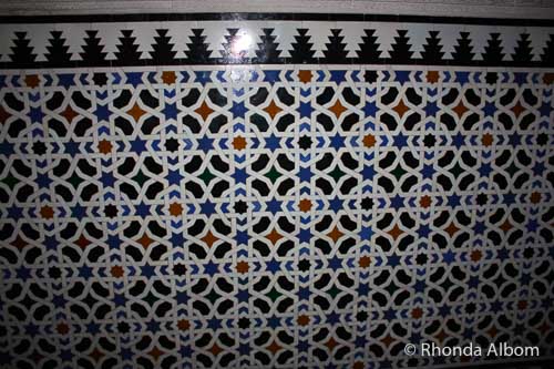 A repeating tile wall pattern containing the Star of David in the Alcazar in Seville Spain
