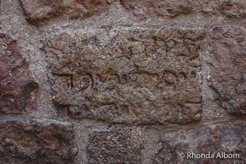 Hebrew letters carved into a wall in Old Town Barcelona