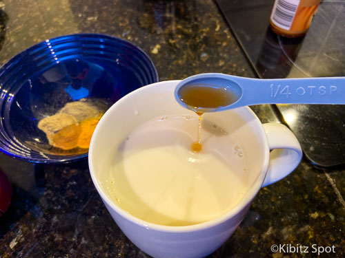 Adding vanilla extract to almond milk to make a turmeric latte