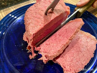 A plate of our homemade simple corned beef recipe, plated with carrots, potatoes, and cabbage.