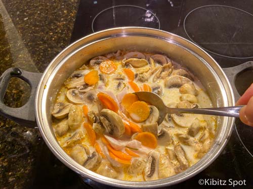 Stirring ingredients for chicken tom kha soup