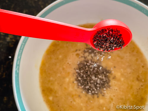 Adding chia seeds to our gluten free banana nut muffins batter