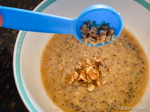 Adding walnuts to our dairy and gluten free banana nut muffins batter