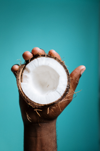 half coconut held in a hand