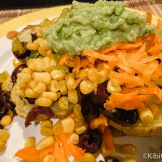 Mexican potato dinner with corn, avocado, black beans, olives, and more great baked potato bar ideas