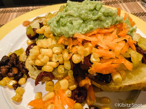 Mexican potato dinner with corn, avocado, black beans, olives, and more great baked potato bar ideas