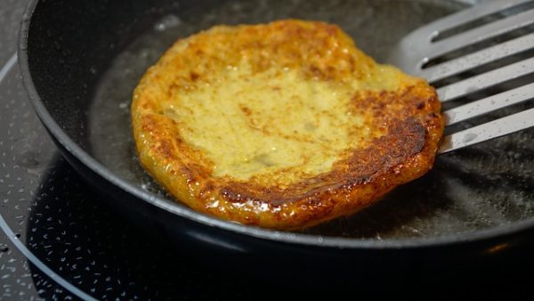 Potato pancake in the pan, ready to be flipped