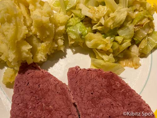 Corned beef, fried cabbage and mashed potato on a plate