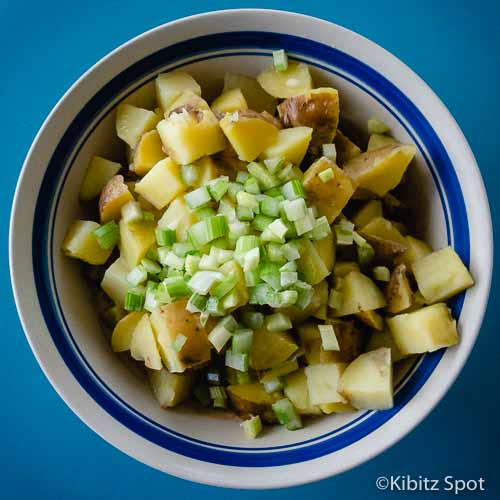 Boiled potatoes and celery in a bowl