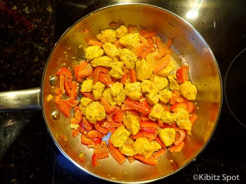 Fish, peppers, and spices frying in the pan