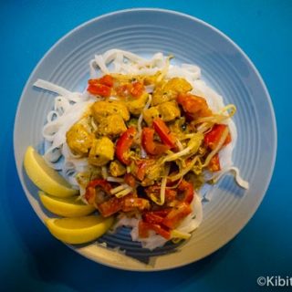 Malaysian fish curry served on a bed of rice noodles