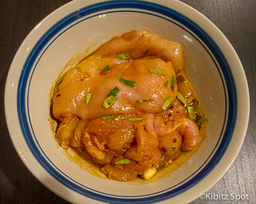 Vietnamese grilled chicken marinating in spicy kaffir lime sauce