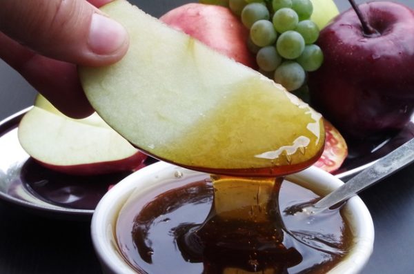 Apple dipped in honey is the classic Rosh Hashanah Food Symbolism.