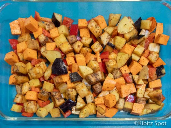 kumara, potato, eggplant, spices, and olive oil diced for egg casserole in an oven safe dish