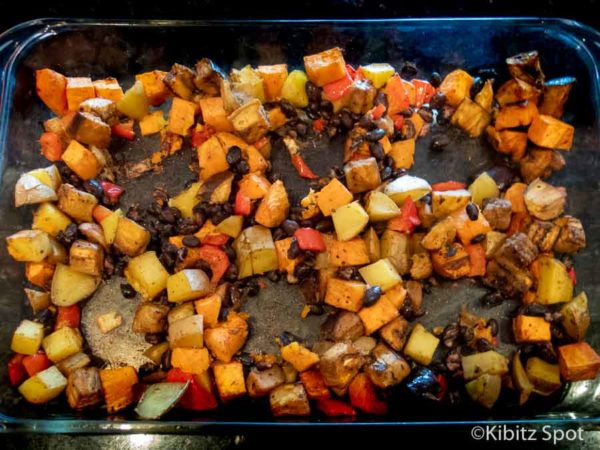 Pan of vegetables and potato with wells for eggs to be added