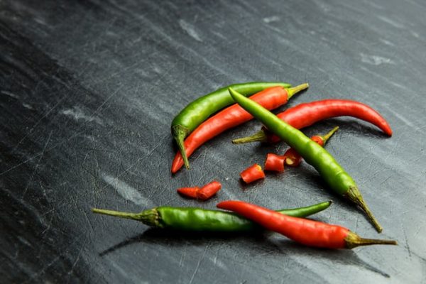 Red and green hot chili peppers chopped and ready to add to a fermented hot sauce recipe