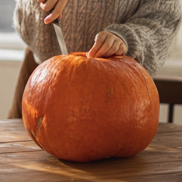 A knife inserted to show how to cut a pumpkin