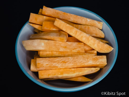 a bowl of uncooked sweet potato fries
