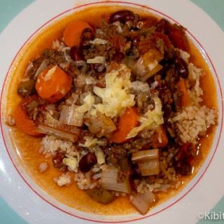 Plate of tex mex chili con carne with cheese melted on top