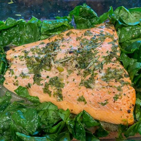 Baked salmon and spinach in a pan
