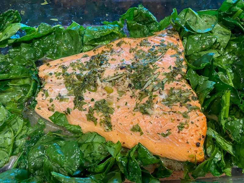 Baked salmon and spinach in a pan