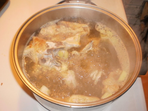 Chicken broth boiling in a stockpot