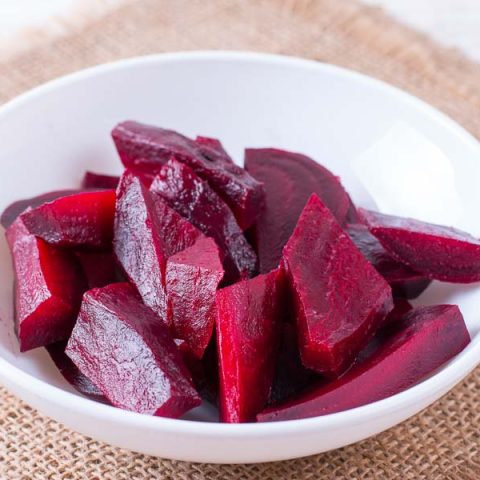 Steamed beets sliced and ready to serve in a bowl