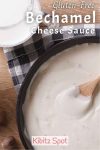 A pan of creamy Gluten Free Bechamel cheese Sauce with a wooden spoon, on a blue checkered cloth