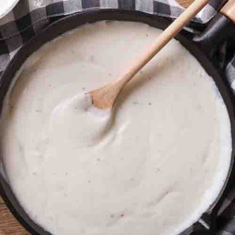 Creamy bechamel sauce stirred in a pan
