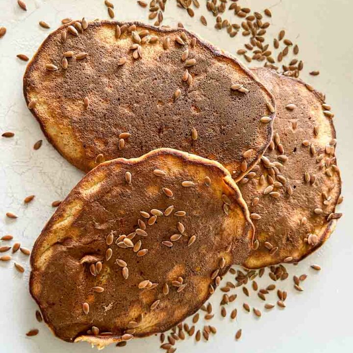 Delicious peanut butter banana pancakes on a plate. They are grain-free, gluten-free and dairy-free.