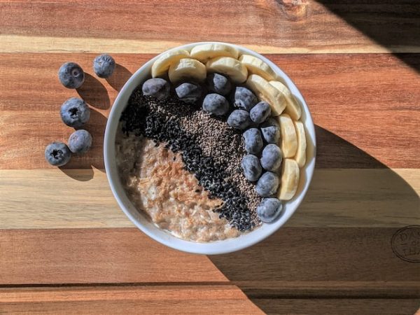 Bowl of chia pudding with blueberries and banana a delicious gluten free vegan breakfast featured at Kibitz Spot