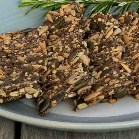 A plate of keto seeded crackers with rosemary