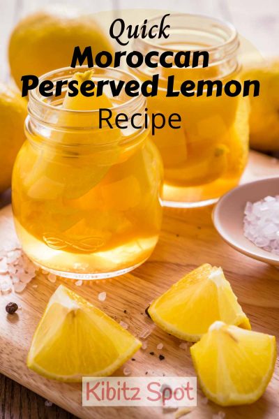 Jars of preserved lemon with the ingredients spread around on a wooden board