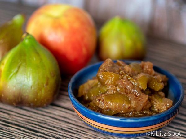 A bowl of our fig chutney recipe with an apple and 2 figs in the background