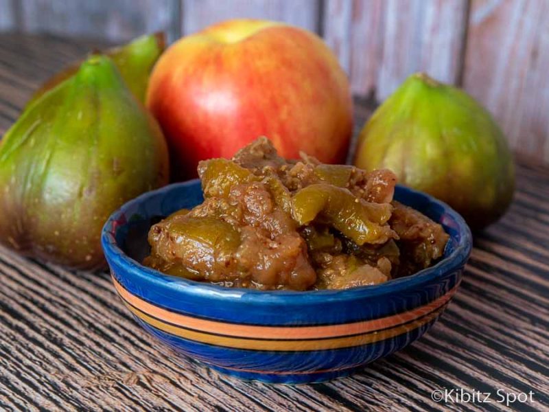A small bowl of our fig chutney with an apples and figs in the background
