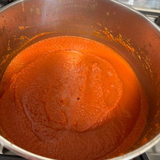 A simmering pot of nomato paste