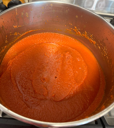 A simmering pot of nomato paste