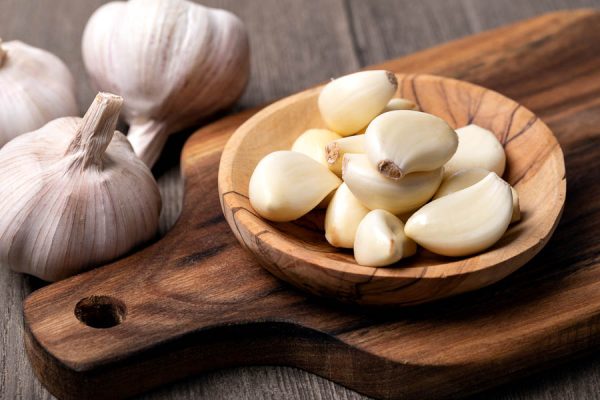 Garlic Cloves and Bulb in vintage wooden bowl