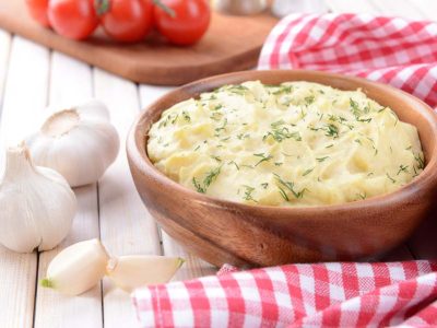 A bowl of gluten-free garlic mashed potatoes ready to serve.