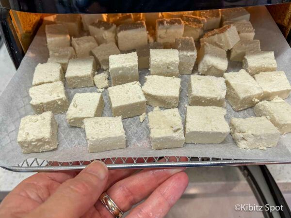 Easy Crispy Air Fryer Tofu Nuggets: Vegan and Gluten-Free 3 Tofu nuggets on an air fryer tray ready to be cooked
