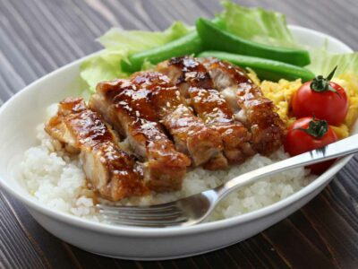 A plate of gluten-free teriyaki chicken over rice.