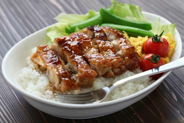 A plate of gluten-free teriyaki chicken over rice.