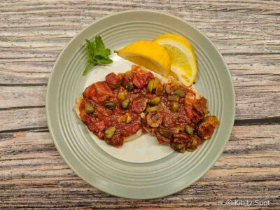 Snapper Veracruz on a plate with lemon.