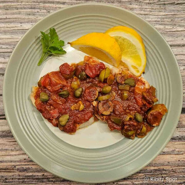 Snapper Veracruz on a plate with lemon