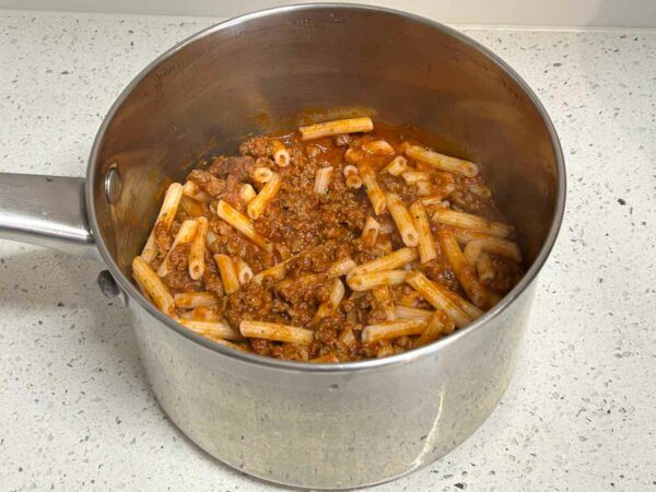 A pot of penne pasta with our marinara sauce with sausage