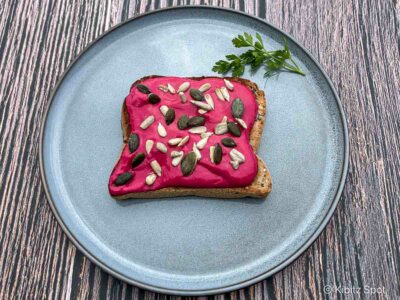 Whipped tofu with beetroot on toast and topped with seeds