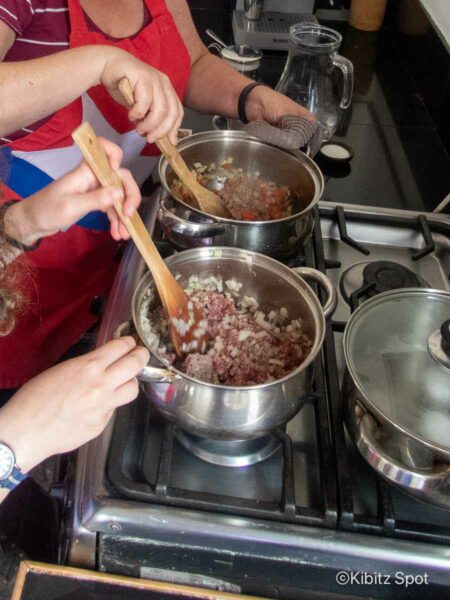 First step in making charquican is browning the meat, onions and peppers