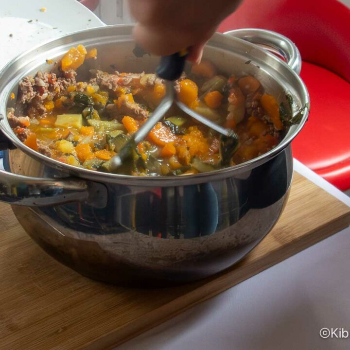 Mashing the cooked ingredients for charquican