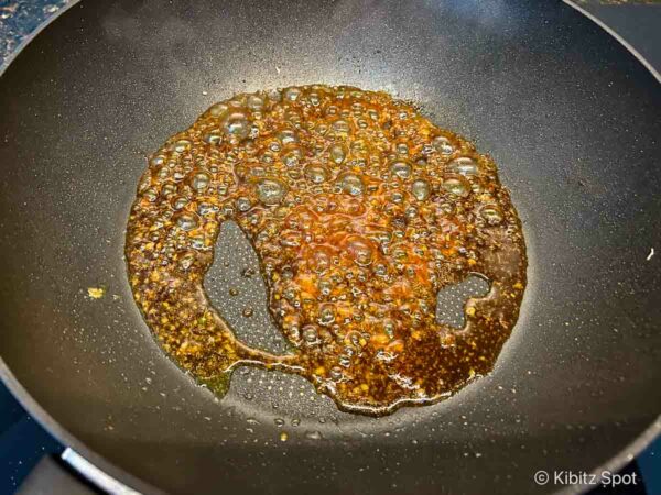 Ginger sauce being thickened prior to coating the beef and broccoli