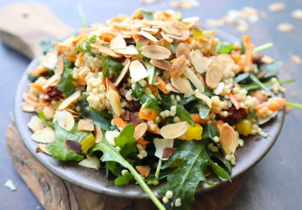 Arugula with millet, sundried tomatoes, bell pepper, and almonds
